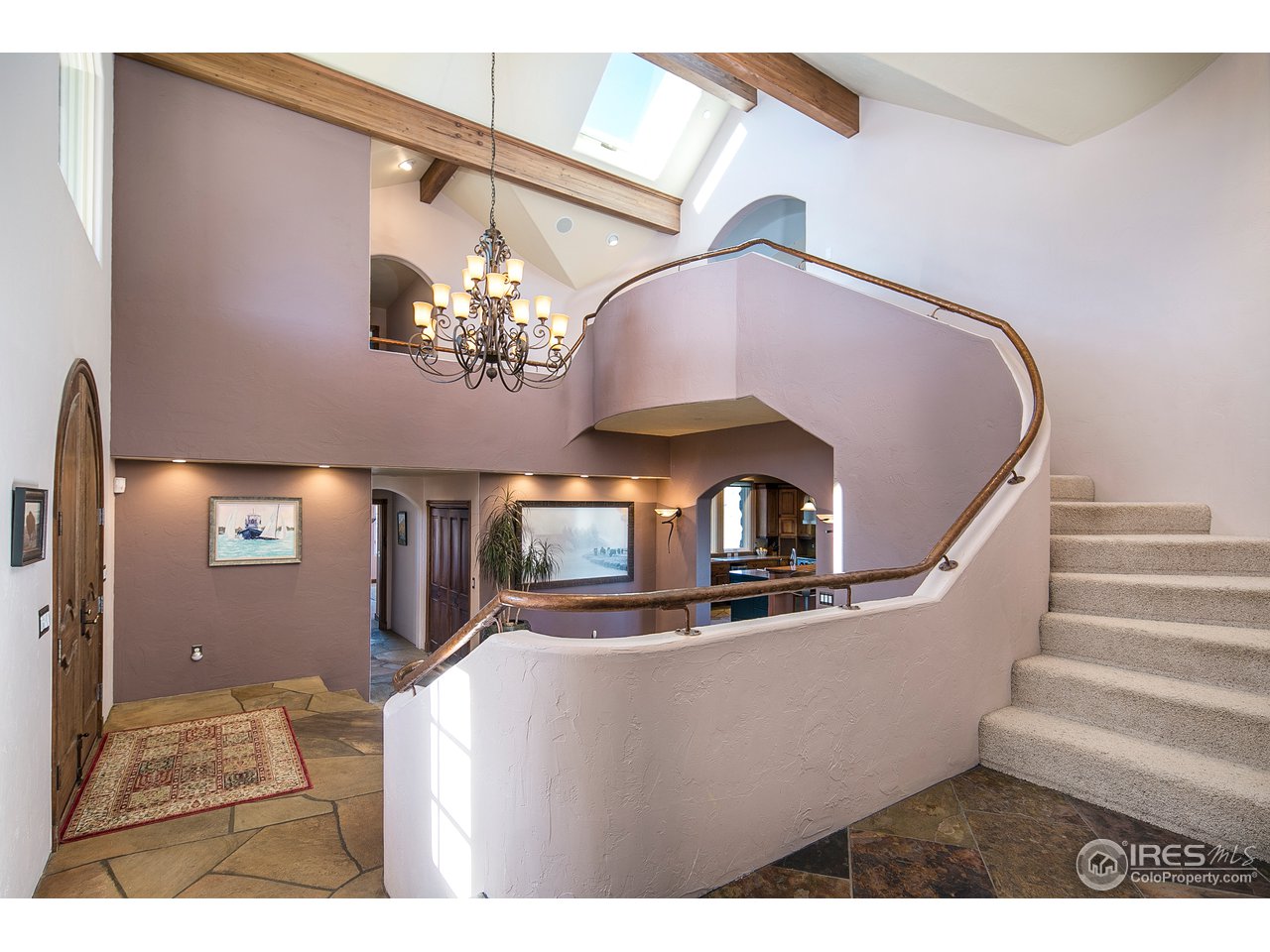 355 Mountain King Road Boulder, CO 80302 - Photo 11 of 34 a view of a livingroom with a fireplace a chandelier and wooden floor