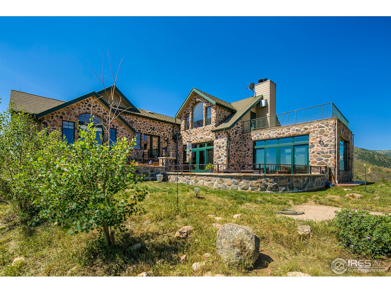 355 Mountain King Road Boulder, CO 80302 - Photo 2 of 34 a view of a house with a big yard and potted plants