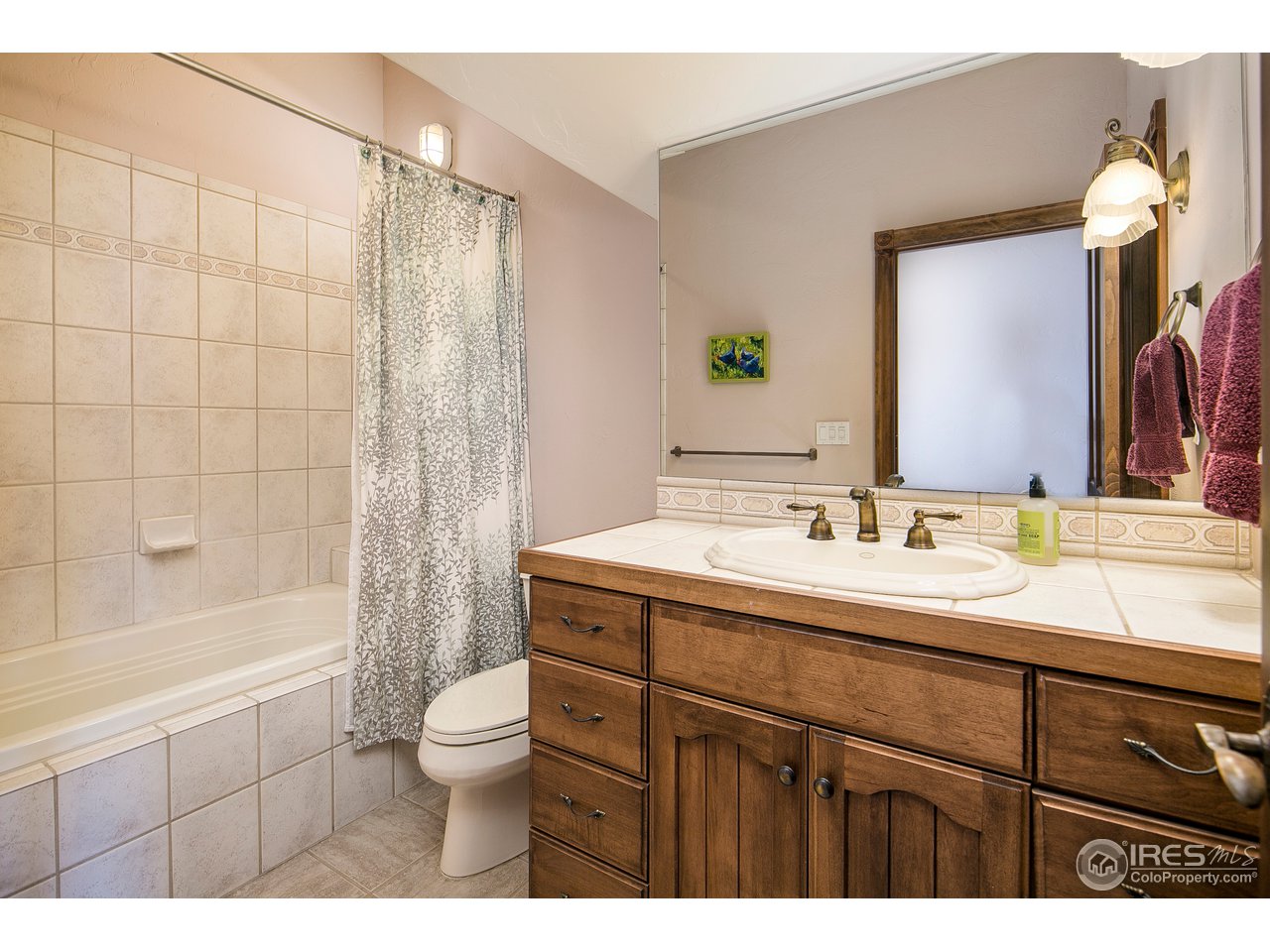 355 Mountain King Road Boulder, CO 80302 - Photo 34 of 34 a bathroom with a granite countertop sink toilet a large mirror a bathtub and shower
