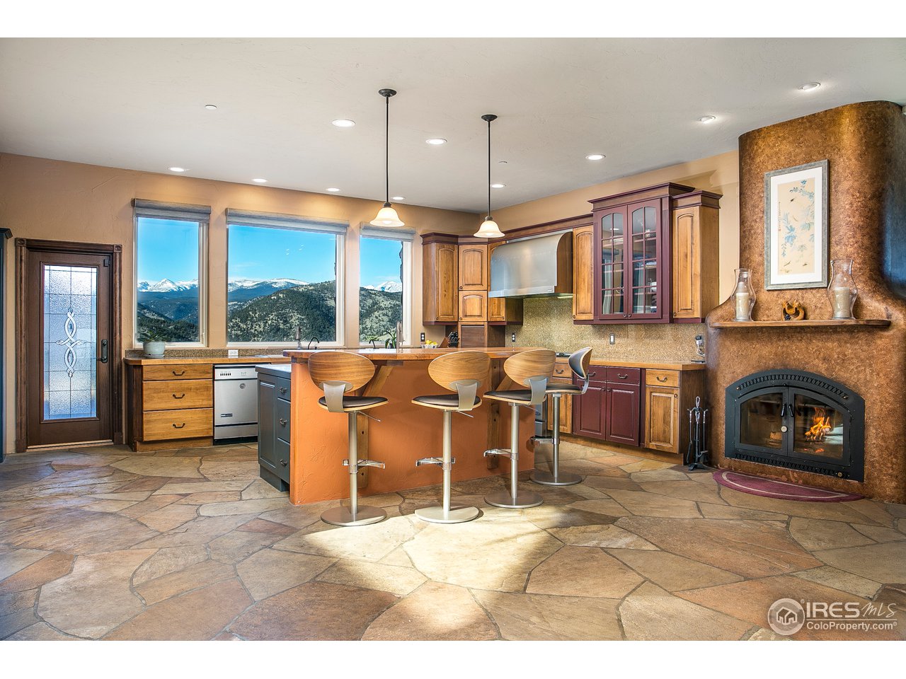 355 Mountain King Road Boulder, CO 80302 - Photo 8 of 34 a open kitchen with cabinets and a fireplace