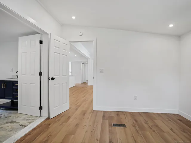 wooden floor in an empty room with a window