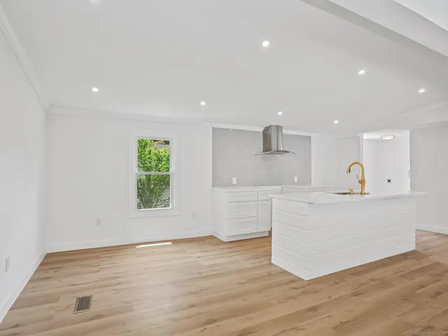 a view of kitchen with wooden floor and window