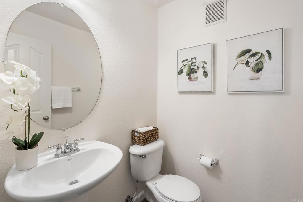 1276 San Elijo Road South San Marcos, CA 92078 - Photo 11 of 34 a bathroom with a toilet sink and mirror