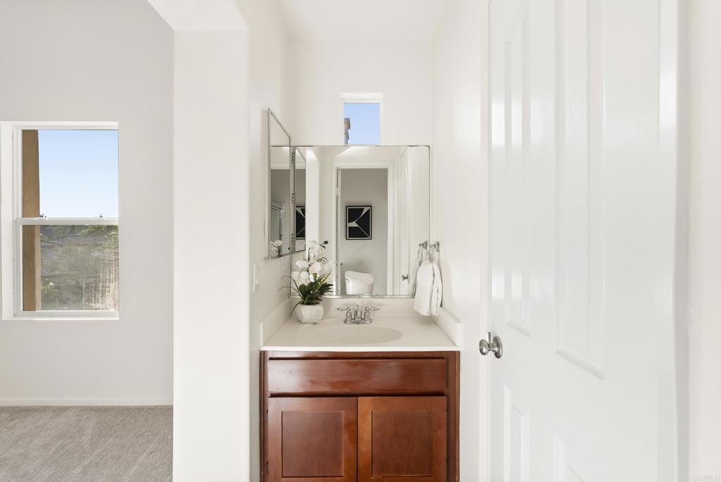 1276 San Elijo Road South San Marcos, CA 92078 - Photo 18 of 34 a bathroom with a sink and a mirror