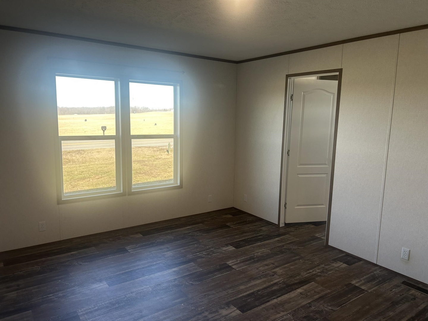 3115 Tunnel Hill Road Ozark, IL 62972 - Photo 12 of 36 an empty room with wooden floor and windows