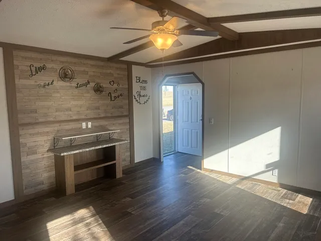 a kitchen with granite countertop a sink a stove and cabinets