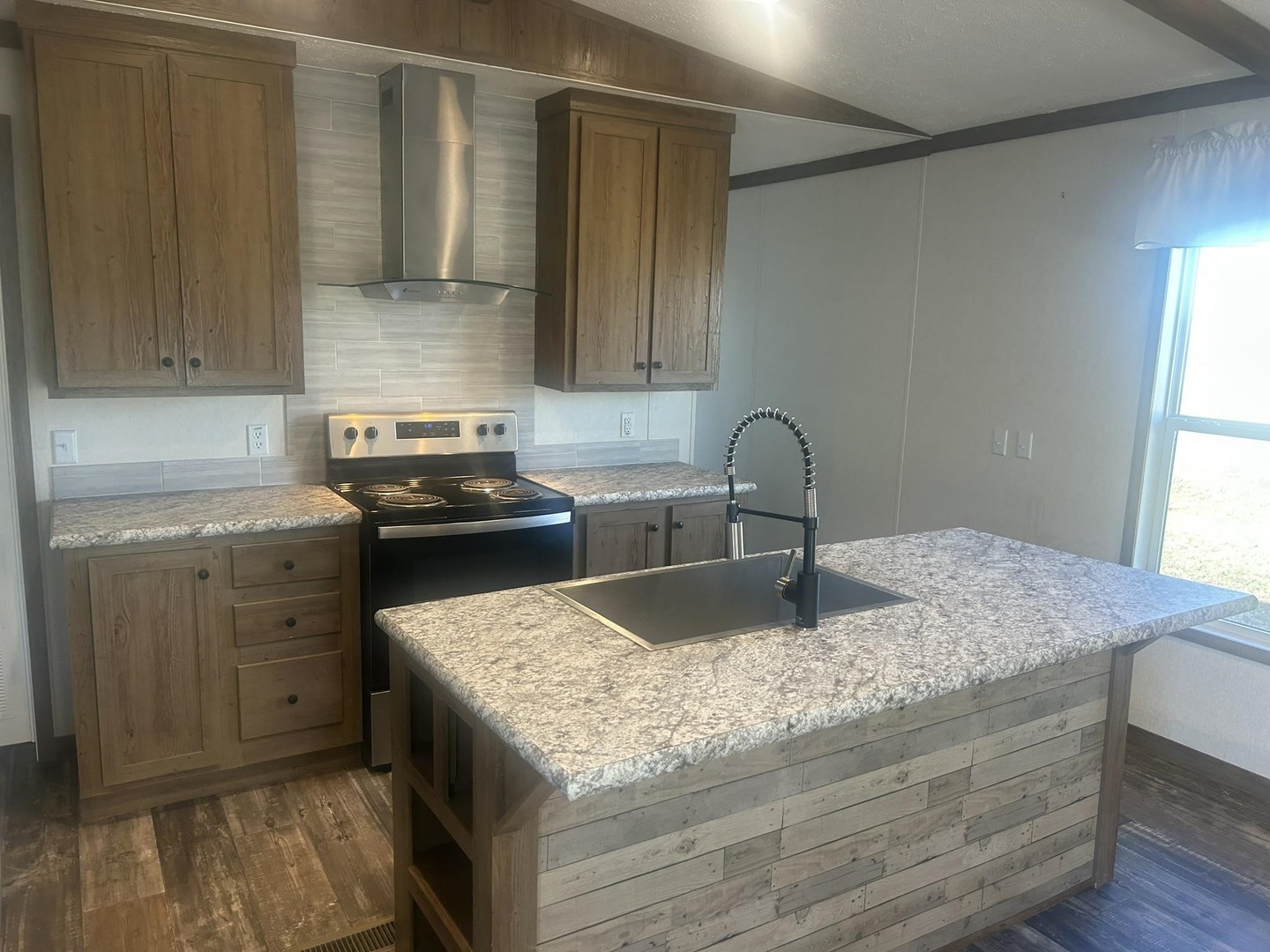 3115 Tunnel Hill Road Ozark, IL 62972 - Photo 19 of 36 a kitchen with granite countertop a sink a stove and cabinets