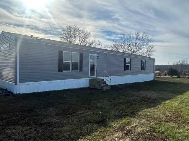 a view of a house with backyard and garden