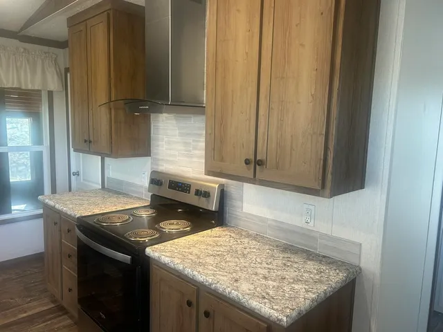 a bathroom with a granite countertop shower a mirror and