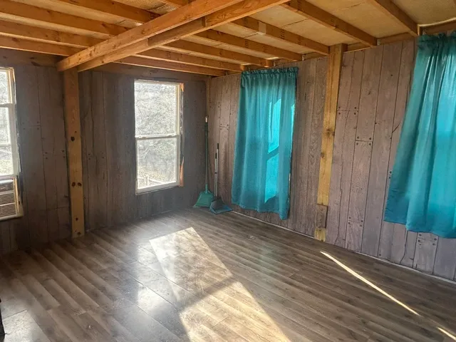 a view of room with wooden floor