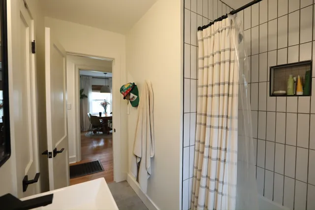 a bathroom with a shower and a sink