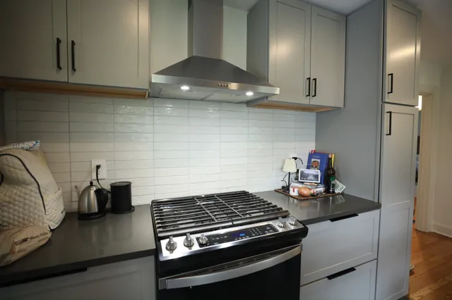 a kitchen with a stove and cabinets