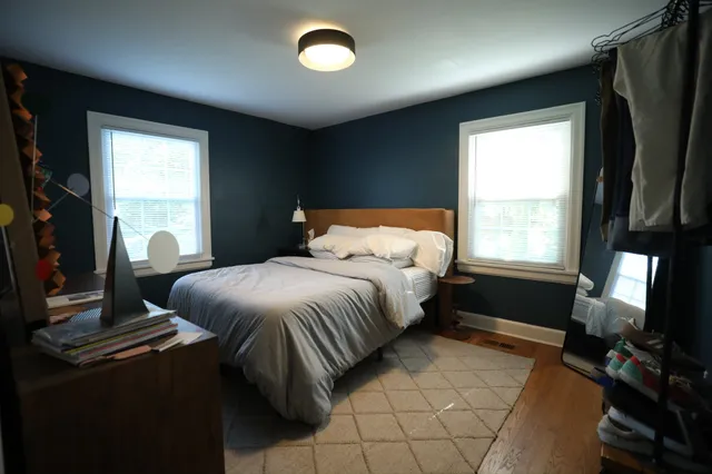 a bed room with a bed dresser and a window