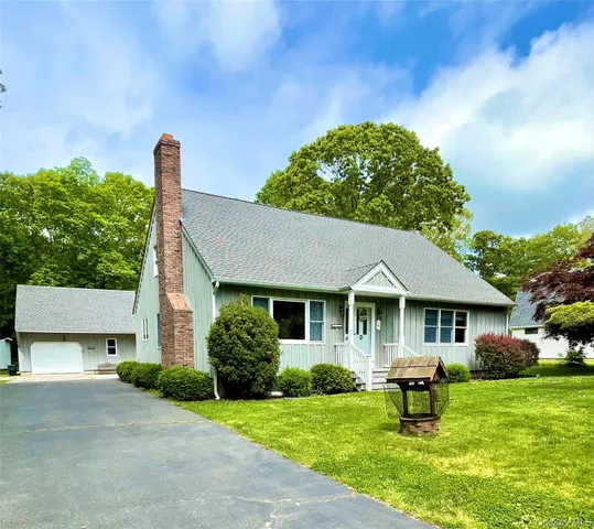 a front view of a house with a garden and porch