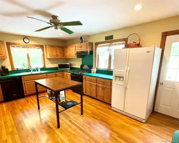 a kitchen with stainless steel appliances granite countertop a stove a refrigerator and a dining table