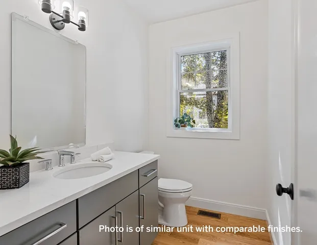 a bathroom with a sink toilet and vanity