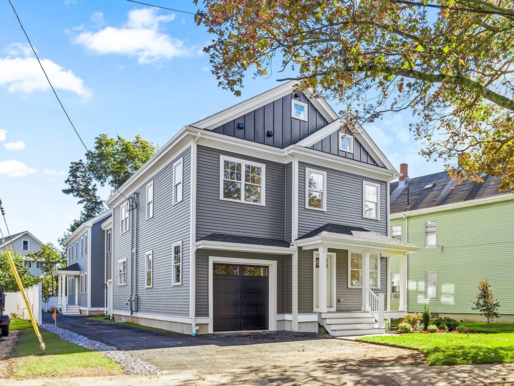 75 Franklin Street, Unit 1 Arlington, MA 02474 - Photo 2 of 36 a front view of a house with a yard