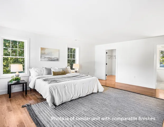 a spacious bedroom with a bed and a large window