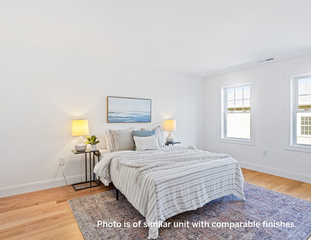 75 Franklin Street, Unit 1 Arlington, MA 02474 - Photo 22 of 36 a bedroom with a bed and wooden floor