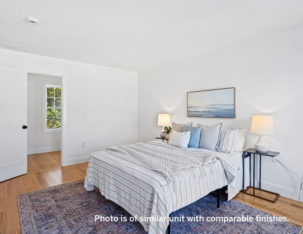 75 Franklin Street, Unit 1 Arlington, MA 02474 - Photo 23 of 36 a bedroom with a bed a rug and a lamp
