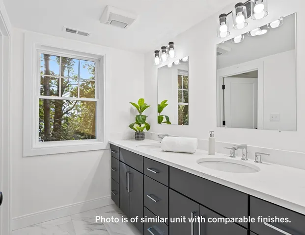a bathroom with a sink double vanity and a mirror