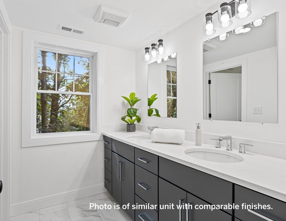 75 Franklin Street, Unit 1 Arlington, MA 02474 - Photo 24 of 36 a bathroom with a sink double vanity and a mirror