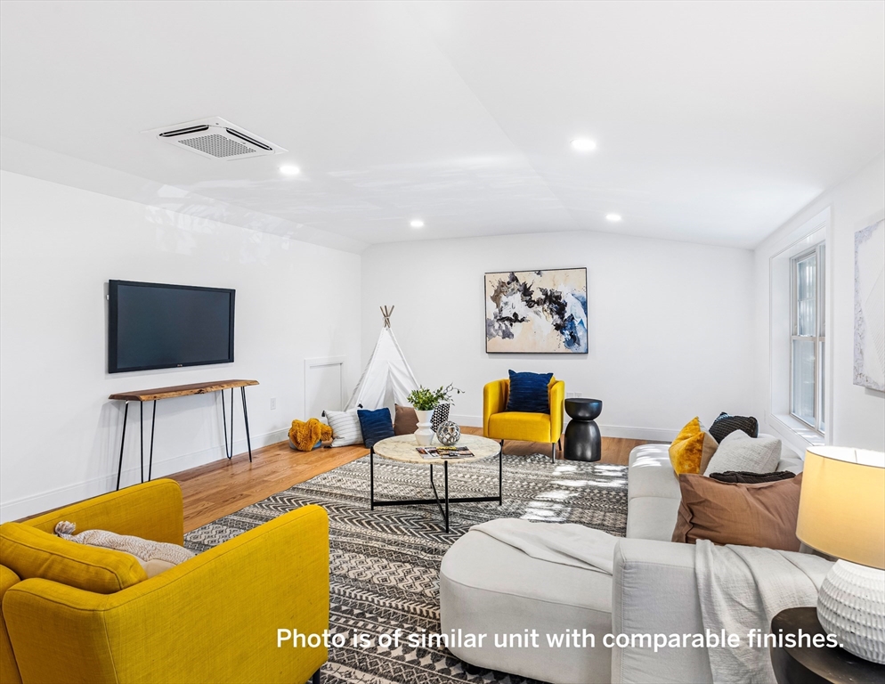 75 Franklin Street, Unit 1 Arlington, MA 02474 - Photo 28 of 36 a living room with furniture and a flat screen tv