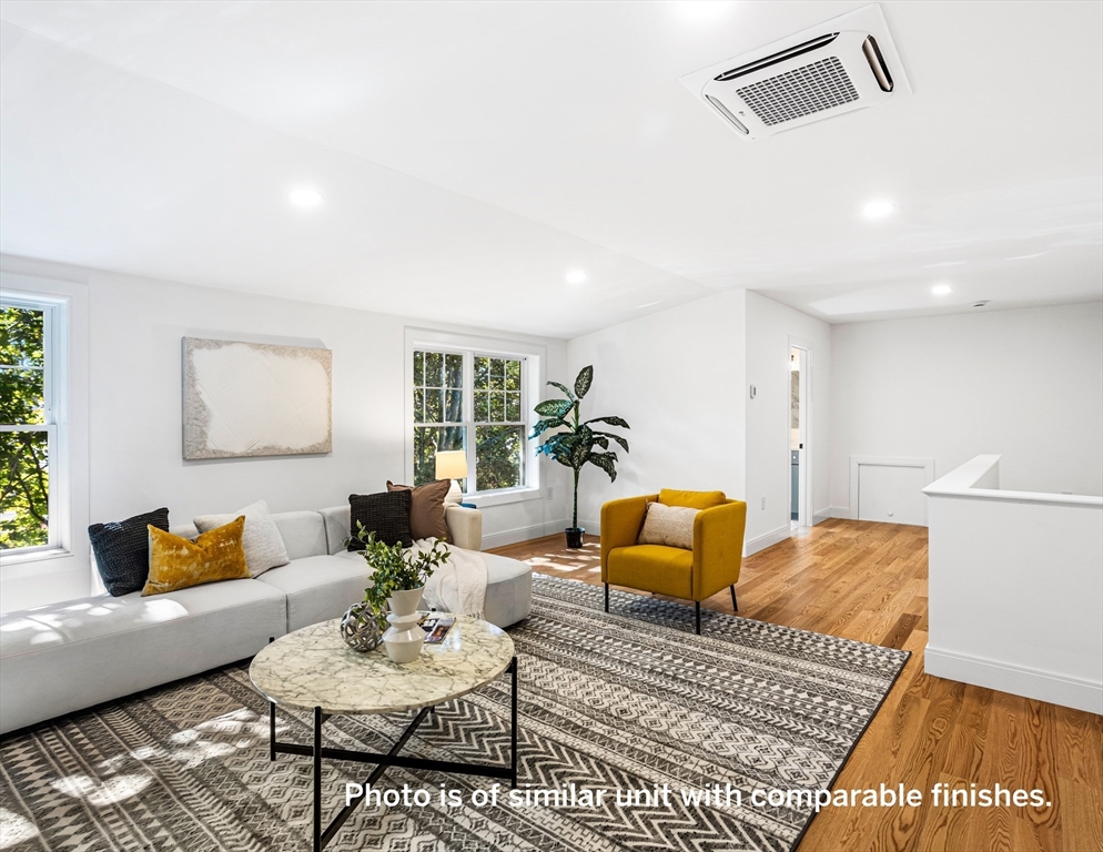 75 Franklin Street, Unit 1 Arlington, MA 02474 - Photo 30 of 36 a living room with furniture and wooden floor