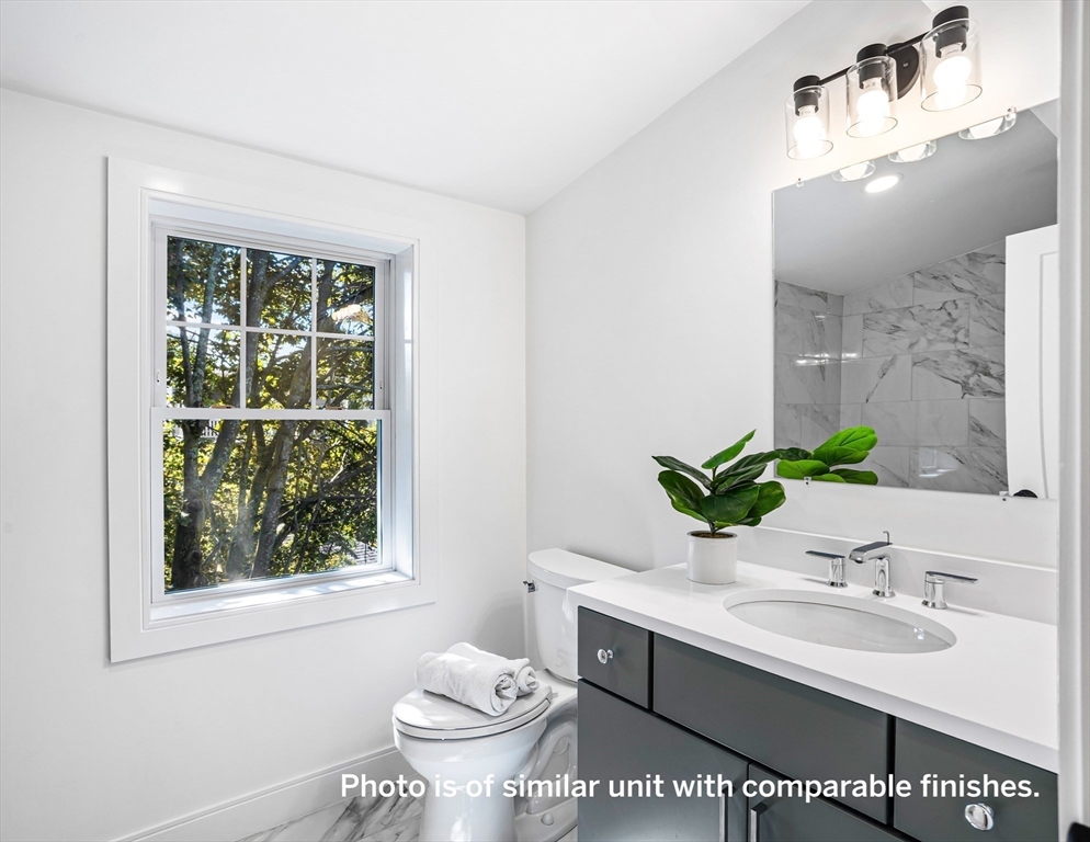 75 Franklin Street, Unit 1 Arlington, MA 02474 - Photo 31 of 36 a bathroom with a sink toilet and mirror