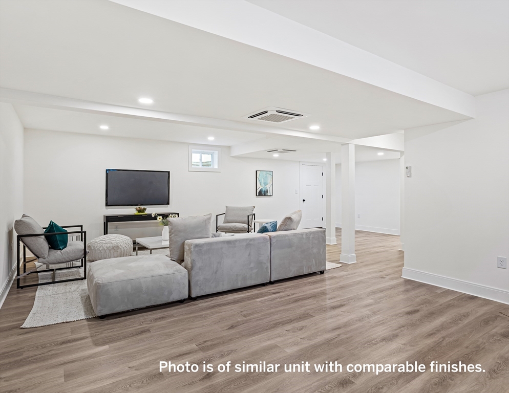 75 Franklin Street, Unit 1 Arlington, MA 02474 - Photo 33 of 36 a living room with furniture and a flat screen tv