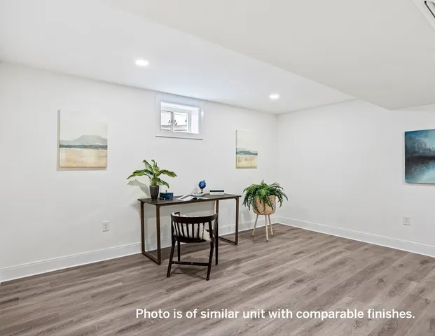 a view of a dining room with furniture and a potted plant