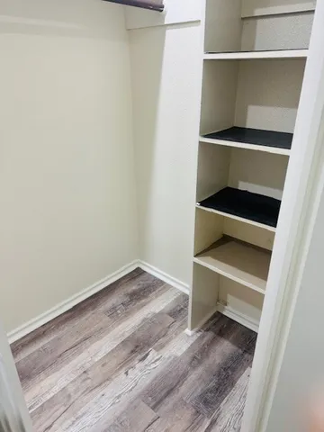 a view of room with wooden floor