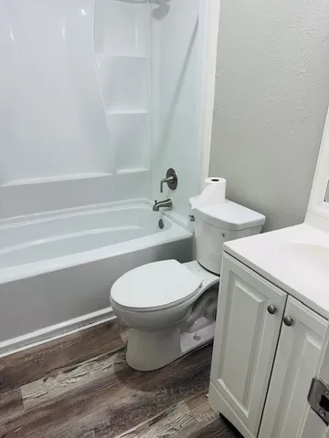 a bathroom with a toilet and a bathtub