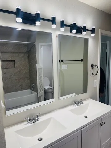 a bathroom with a sink and a mirror