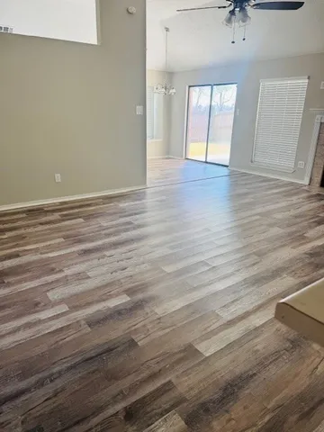 wooden floor in an empty room with a window