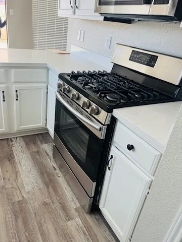 a stove top oven sitting inside of a kitchen