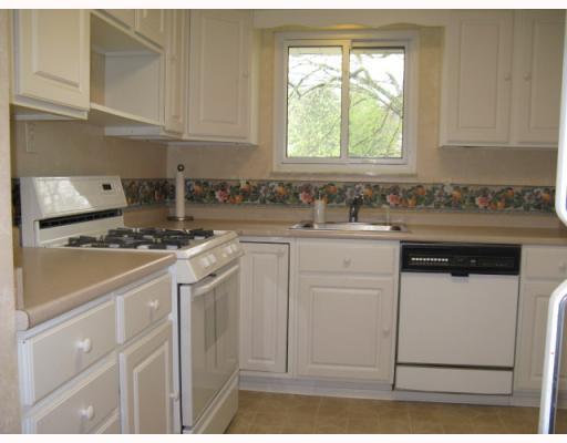 Kitchen. Pretty kitchen with white cabinets, beige counter, beige vinyl floor.  All appliances included:  gas stove, refrigerator, dishwasher, disposal.
