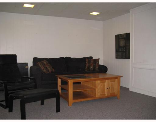 Den/Family/Great Room. Family room with blue/gray Berber carpeting, cream walls, bar.