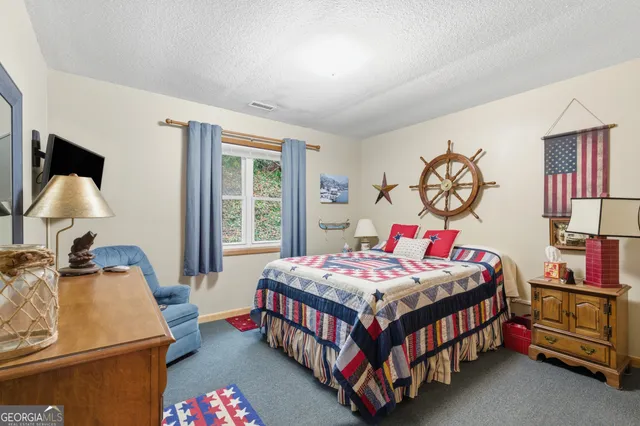 a bedroom with a bed and a table