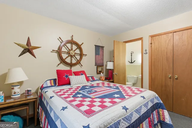 a bedroom with a bed and dresser