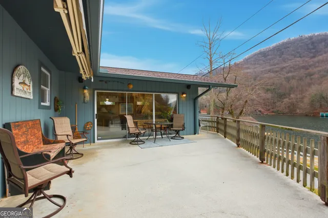 a view of a chairs and table in a balcony