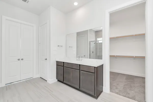 a bathroom with a bathtub shower sink and mirror