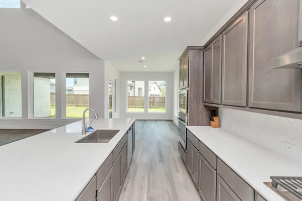 a view of a living room with kitchen island furniture and a kitchen view