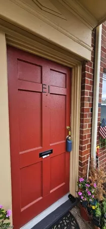 a view of a door and wooden cabinets