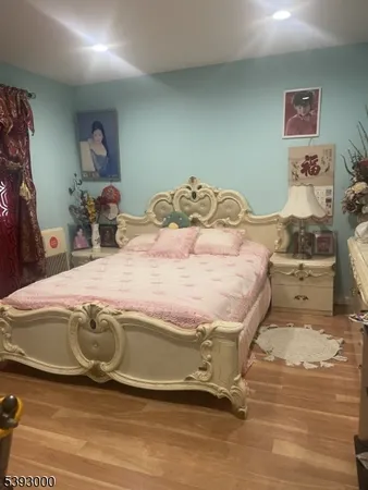 a bedroom with a bed and gym equipment