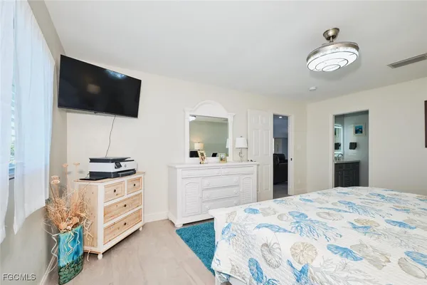 a bedroom with a bed and flat screen tv