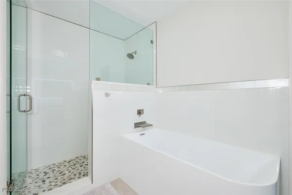 a bathroom with a bathtub and a shower