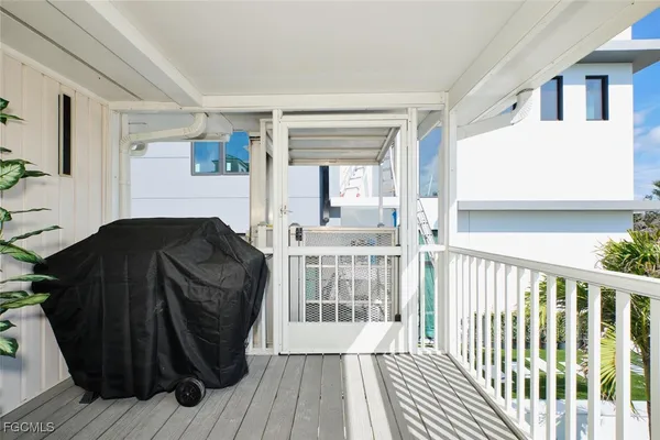 a view of balcony with furniture and wooden floor