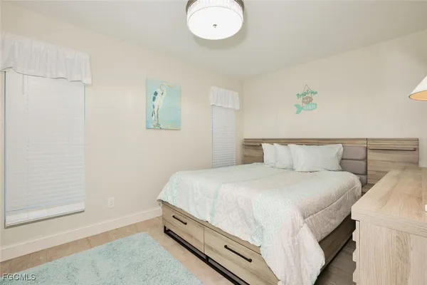 a bedroom with bed and a window
