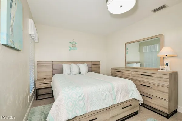 a bedroom with a bed and a dresser